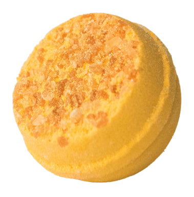 Yellow bath bomb with textured surface on a white background