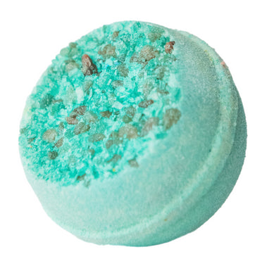 Turquoise bath bomb with specks on a white background