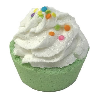 Green bath bomb with white whipped cream and colorful sprinkles on a white background