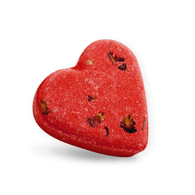 Red heart-shaped candy with chocolate pieces on a white background