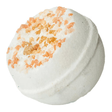 White bath bomb with orange specks on a white background