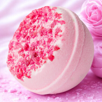 Pink bath bomb with decorative elements on a pink background