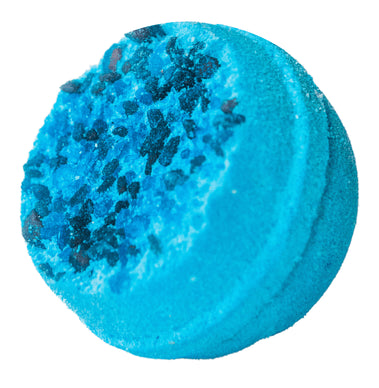 Blue bath bomb with black specks on a white background