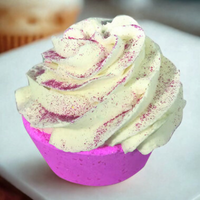 Cupcake with pink and white frosting on a white plate