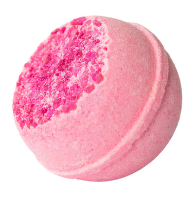 Pink bath bomb with a textured surface on a white background