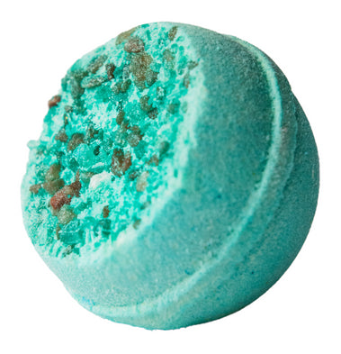 Turquoise bath bomb with green specks on a white background