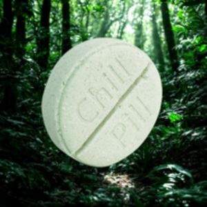 Large green pill with 'Chill Pill' text floating in a forest setting