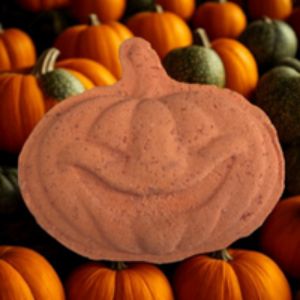 Pumpkin-shaped bath bomb surrounded by real pumpkins