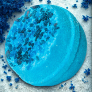 Blue circular object with black specks on a textured white background