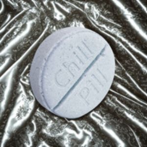 Blue pill-shaped object with 'Chill Pill' text on a reflective surface