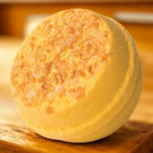 Yellow bath bomb on a wooden surface