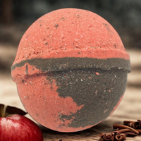 Bath bomb with red and black color scheme on a wooden surface