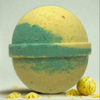 Bath bomb with green and yellow coloration on a white background
