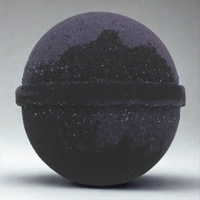 Black spherical object with textured surface on a gray background