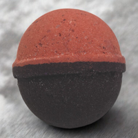 Round object with a red top and black bottom on a gray background