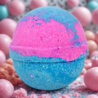 Blue and pink bath bomb with pink and purple spherical objects in the background