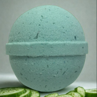 Green bath bomb with cucumbers on a white background