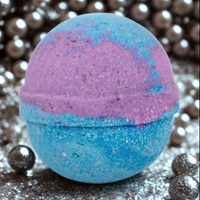 Blue and purple bath bomb with glittery texture on a reflective surface