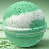 Green bath bomb with a white stripe on a green background
