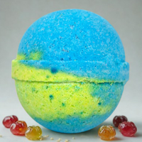 Blue and green bath bomb with colorful gummy bears on a gray background