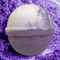Bath bomb on a bed of purple bath salts