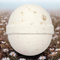 White spherical object on a grassy background with small flowers