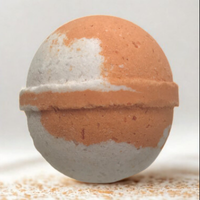 Bath bomb with a gradient from orange to white on a light background