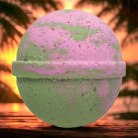 Bath bomb with pink and green colors on a wooden surface with a blurred natural background