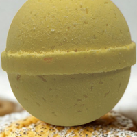 Yellow bath bomb on a textured surface