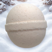 Beige bath bomb on a snowy background