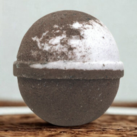 Round stone-like object with a white top on a wooden surface
