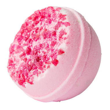 Pink bath bomb with a textured surface on a white background