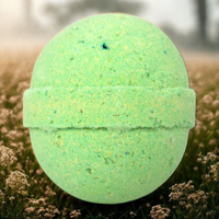 Green bath bomb on grass with a blurred natural background
