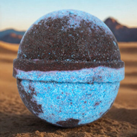 Blue and brown spherical object on a desert landscape